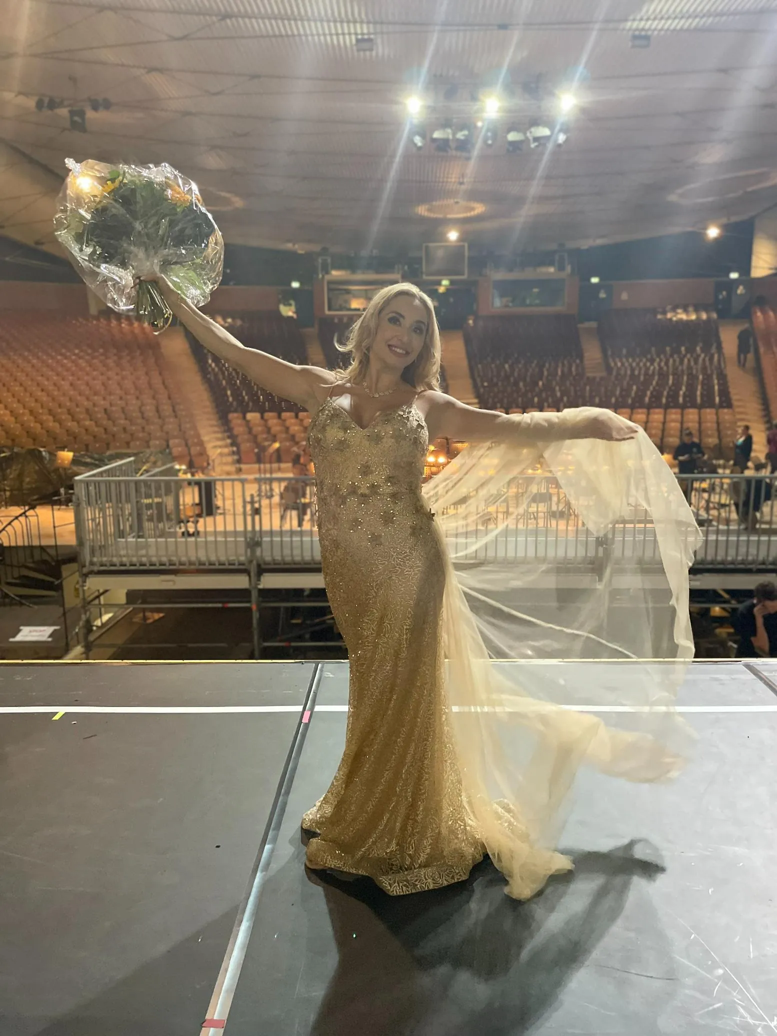 Venicia Rasmussen arena performance in gold gown